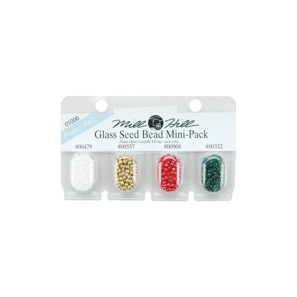 Small blister pack of glass beads in the colors white, gold, red and green