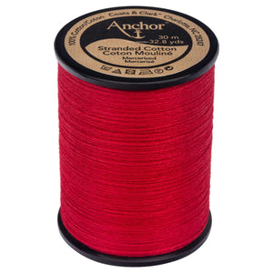 Anchor brand red embroidery floss on a large black plastic spool